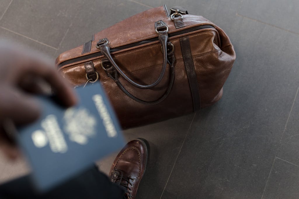 Brown leather bag with a passport at an airport—perfect travel image for Russia trips