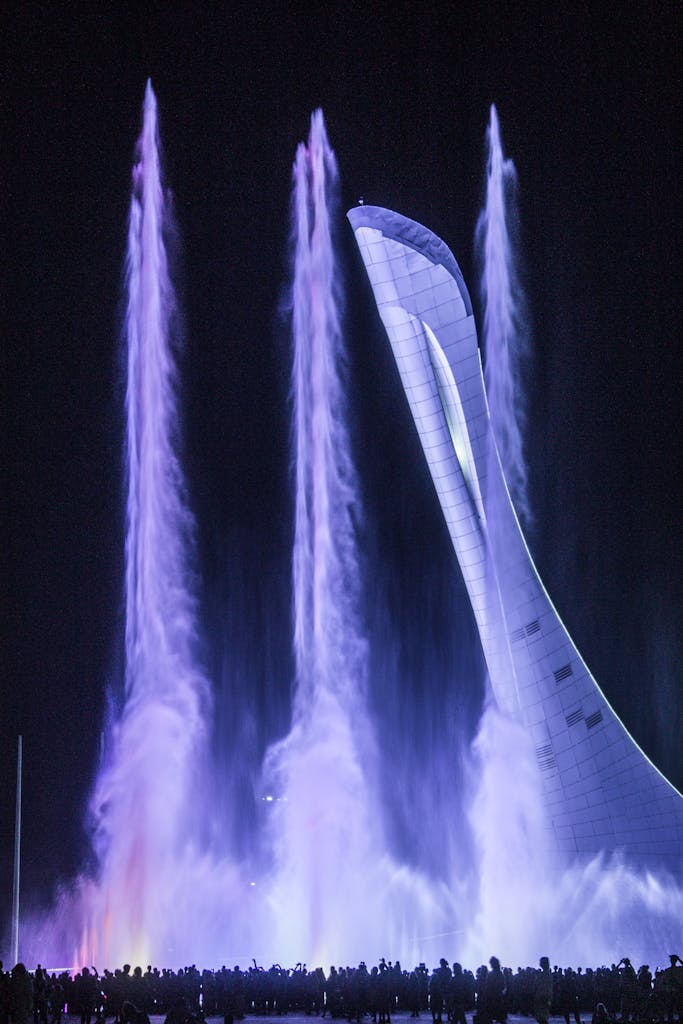 Night view of the Sochi Olympic Flame Tower with illuminated water fountains